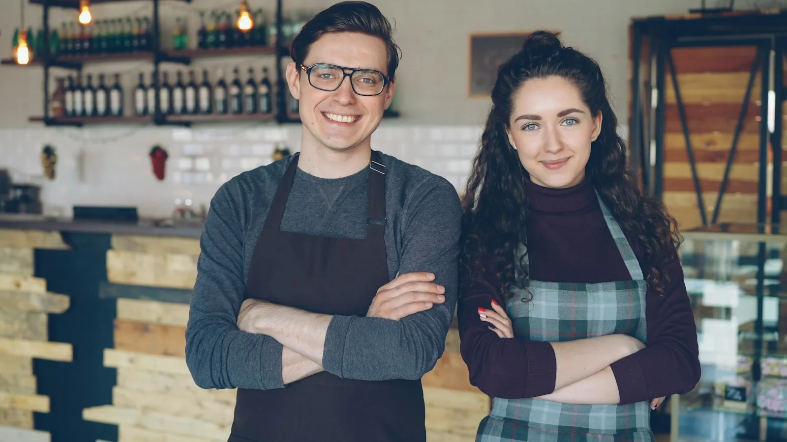 Two small business owners standing in their café