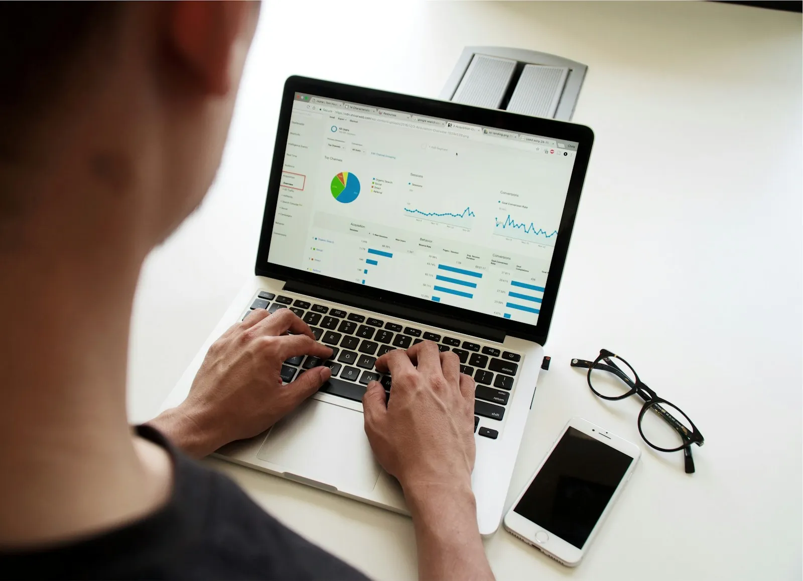 Marketer reviewing website analytics on a laptop